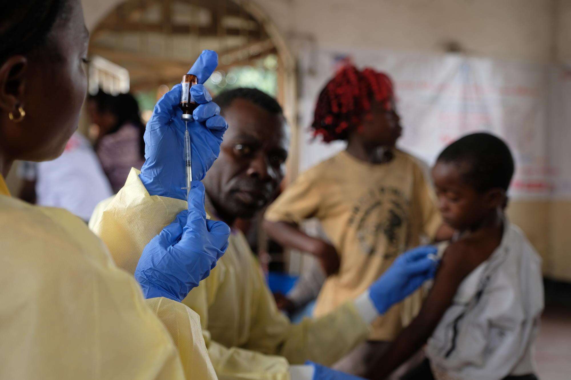 A health worker from the Congolese Ministry of Health prepares to administer a measles vaccine.