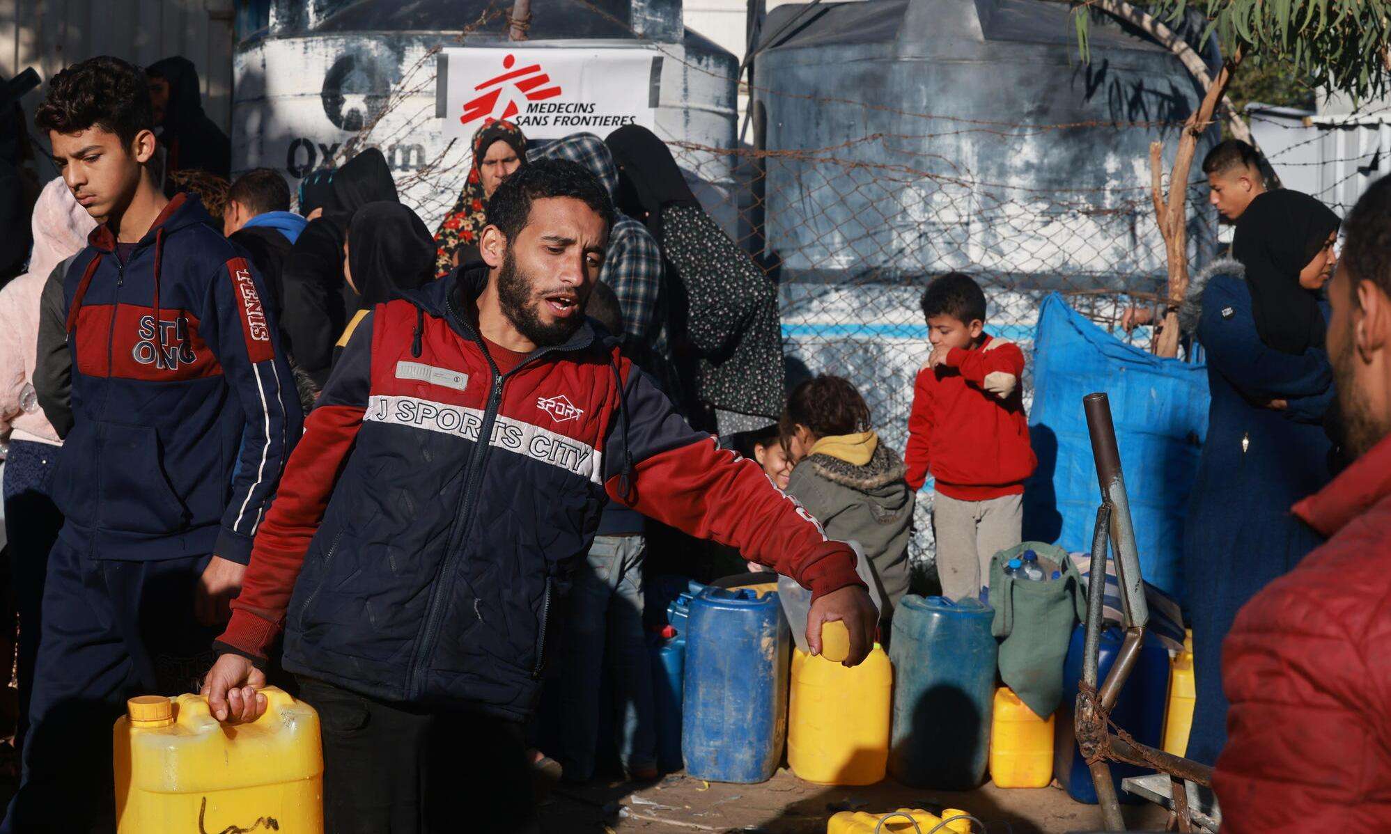 People collecting water from the MSF distribution point, Rafah, south of Gaza.