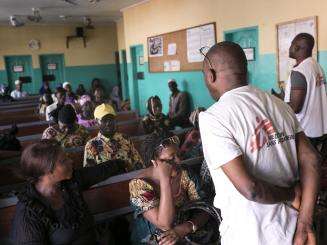 MSF educator Dialloumo Mohammed Taiboe conducts an HIV sensitization session in the waiting area of the MSF-supported HIV outpatient department at Matam Health Center in Conakry, Guinea.