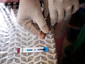 A pregnant woman has an HIV test done in the maternity unit at Matam health center in Guinea.