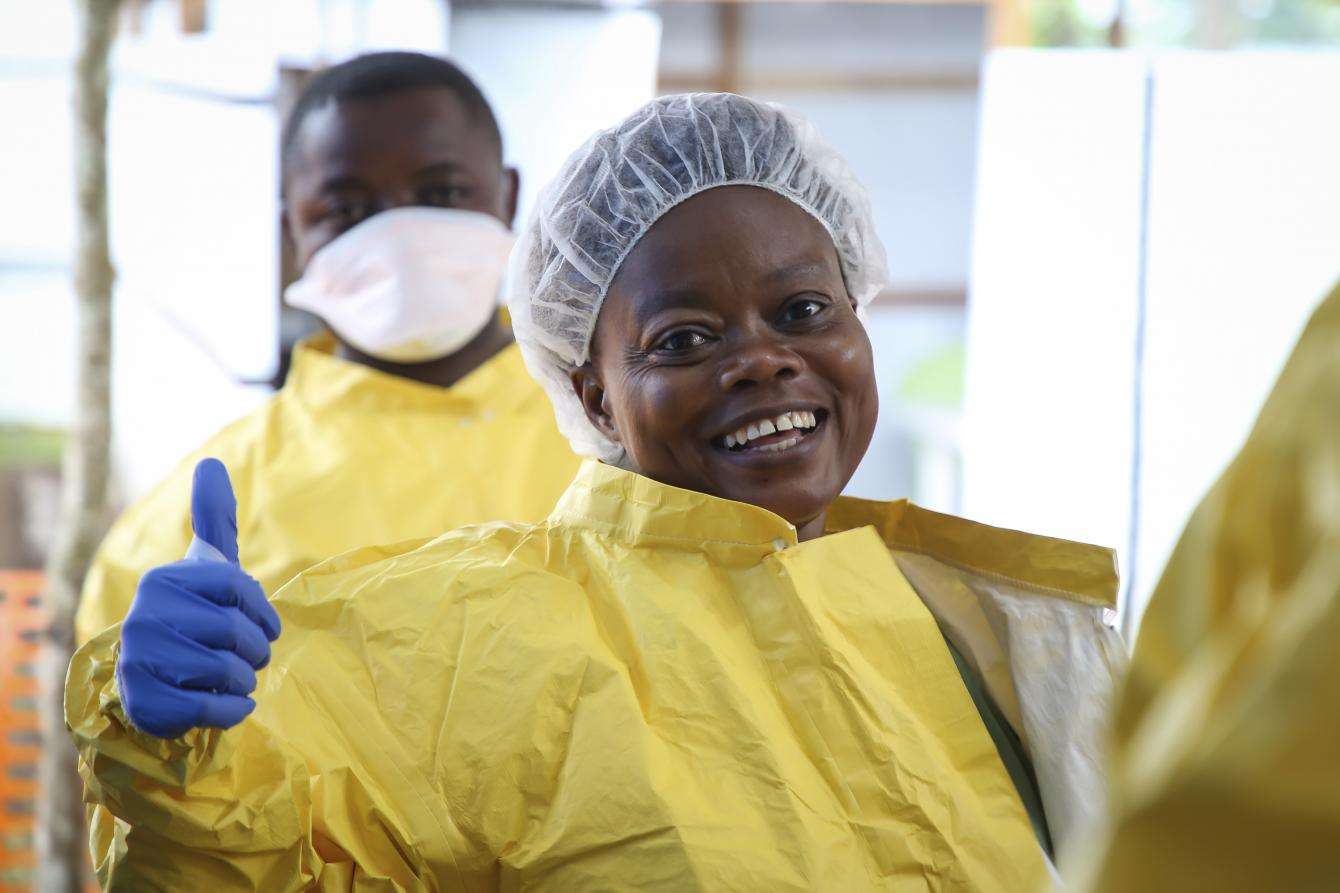 MSF nurse dons personal protective equipment as she prepares to enter the Ebola treatment center