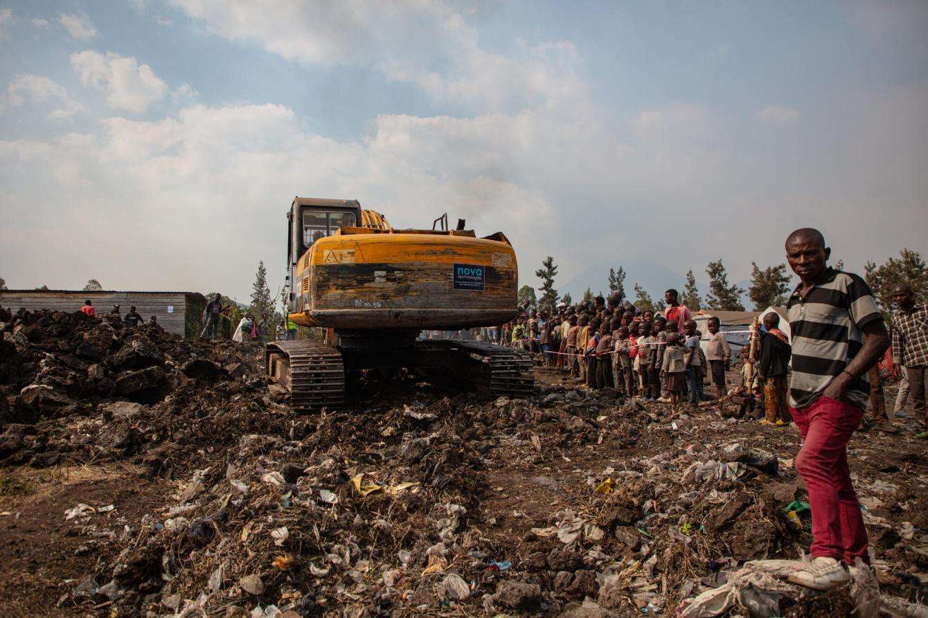 A bulldozer on mound of dirt where MSF is constructing latrines in a displacement camp near Goma, Democratic Republic of Congo