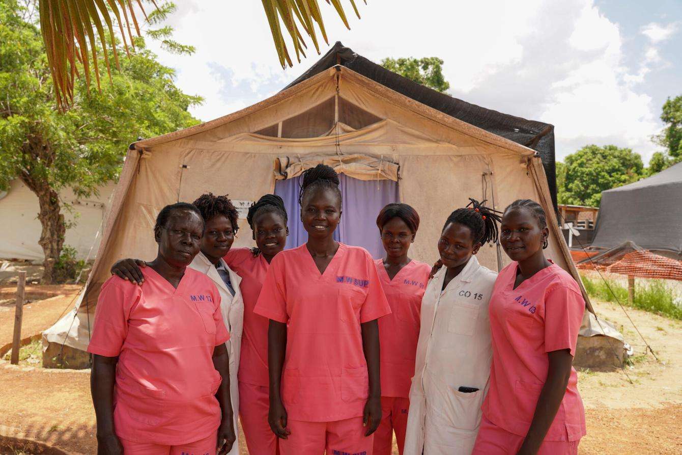 Guo Beatrice Cosmas, MSF midwife supervisor, with team members in front of the labor and delivery tent at Mundari County Hospital in South Sudan.