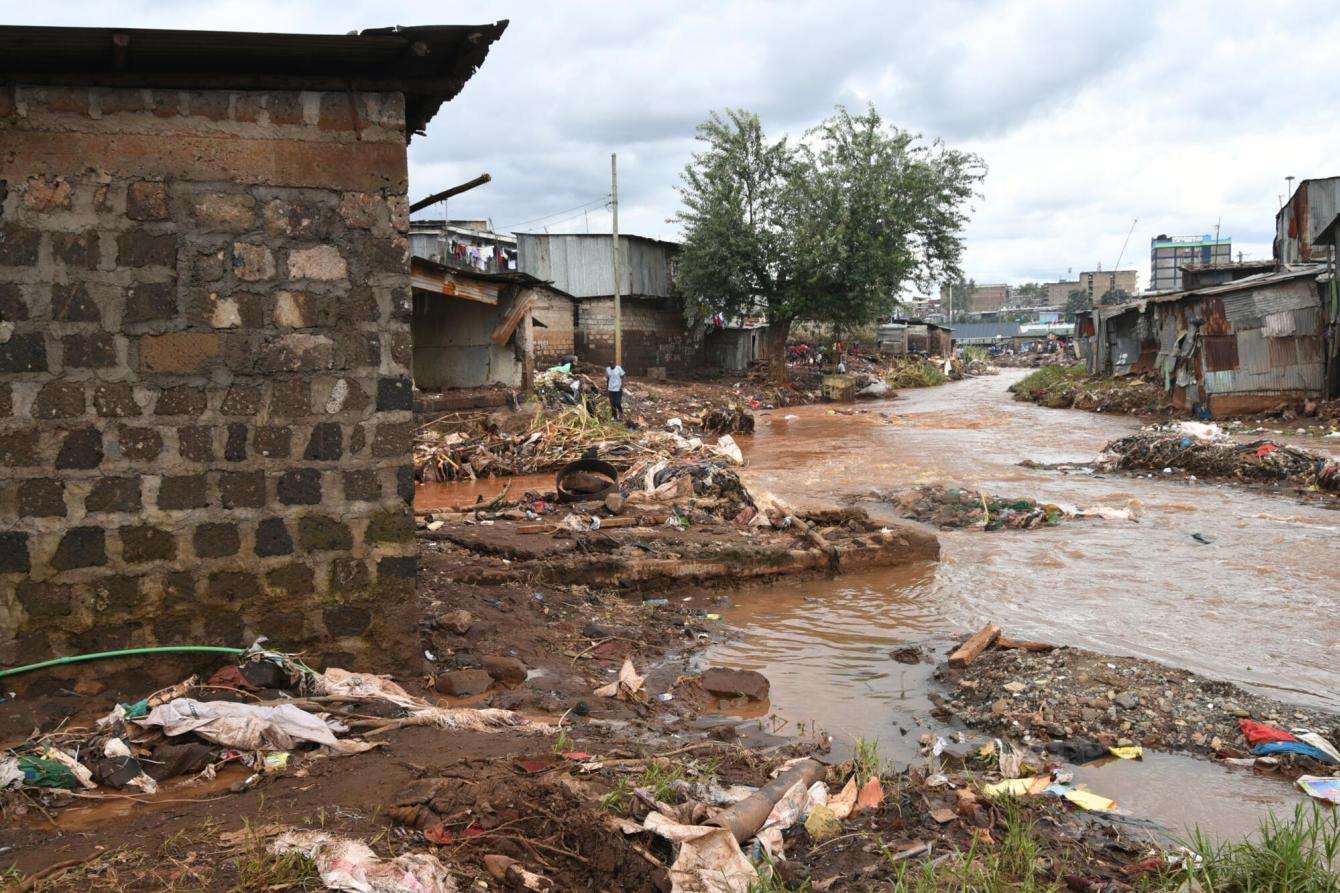 Remains of a  toilet structure (left) next to river Mathare after the flooding in Mathare