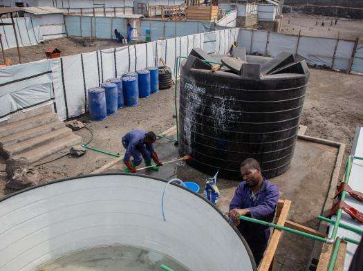 MSF water and sanitation teams operate the new water treatment station at Lushagala displacement camp in Democratic Republic of Congo.