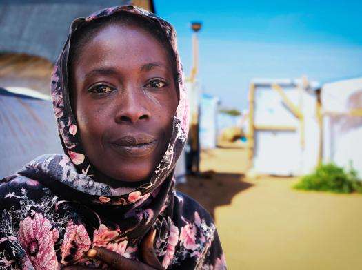 A Sudanese refugee woman in a patterned headscarf in Metche camp, eastern Chad.