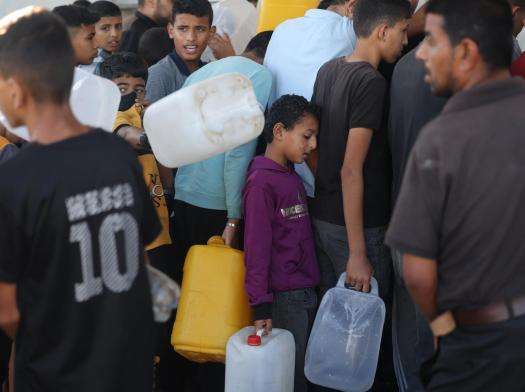 Palestinians line up for water in Khan Younis. 