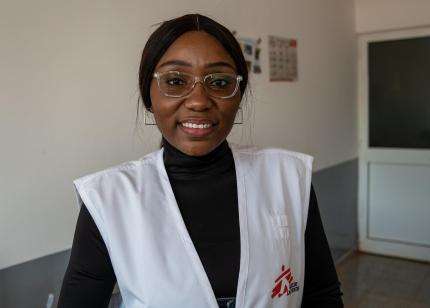 A woman wearing a Doctors Without Borders vest and glasses in Cuvango Municipal Hospital, Angola.