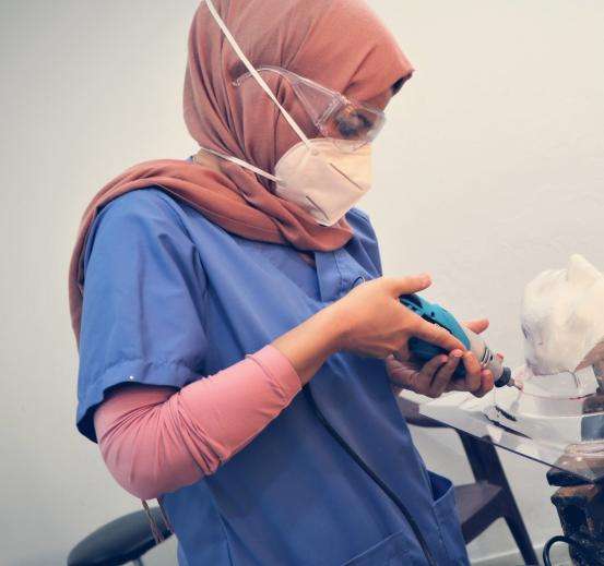 Reem Abu Lebdeh making a 3D mask in Gaza.