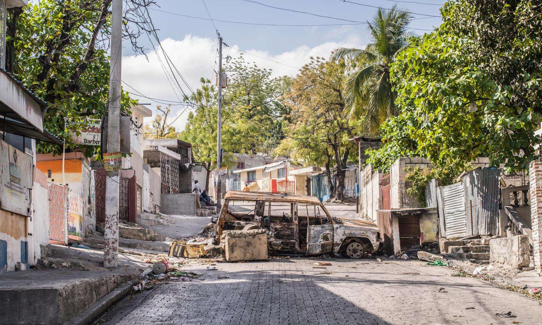 A destroyed car blocking a road in Port-au-Prince, Haiti.